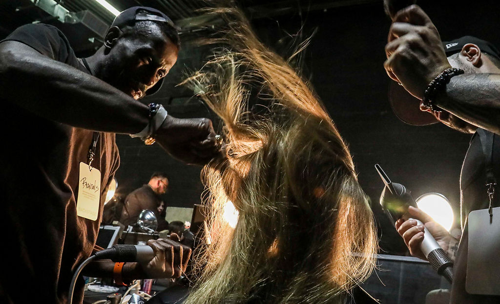 Stylists prepare a model for the runway